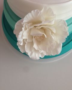 Svatební dort - tyrkysovo-bílý s bílou květinou