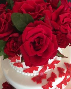 svatební dort - živé červené růže a červení motýlci